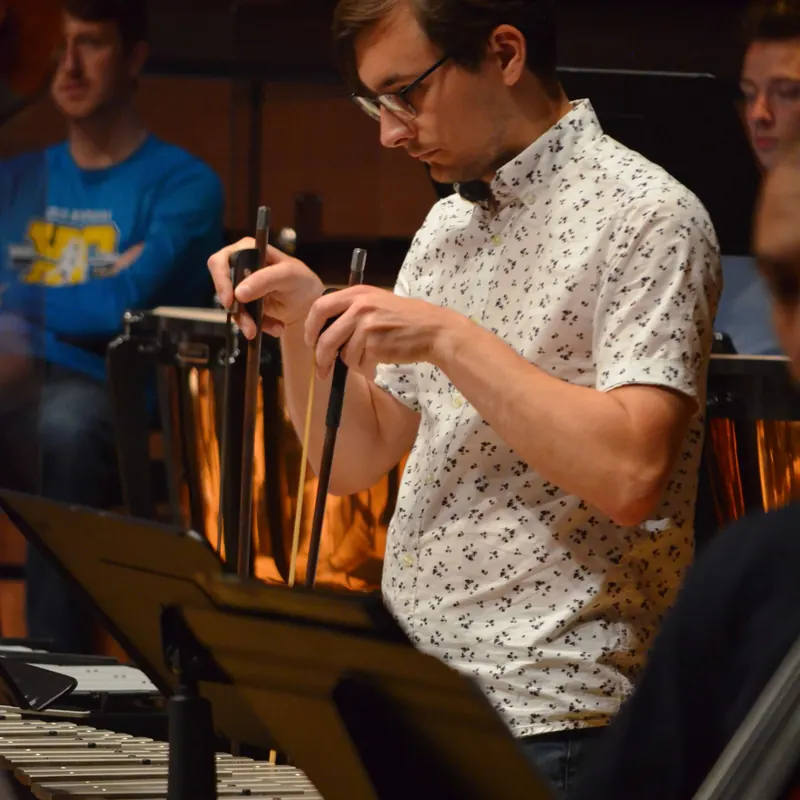 Jacob Kryger bowing a glockenspiel in an NYO Canada composition reading session in 2022